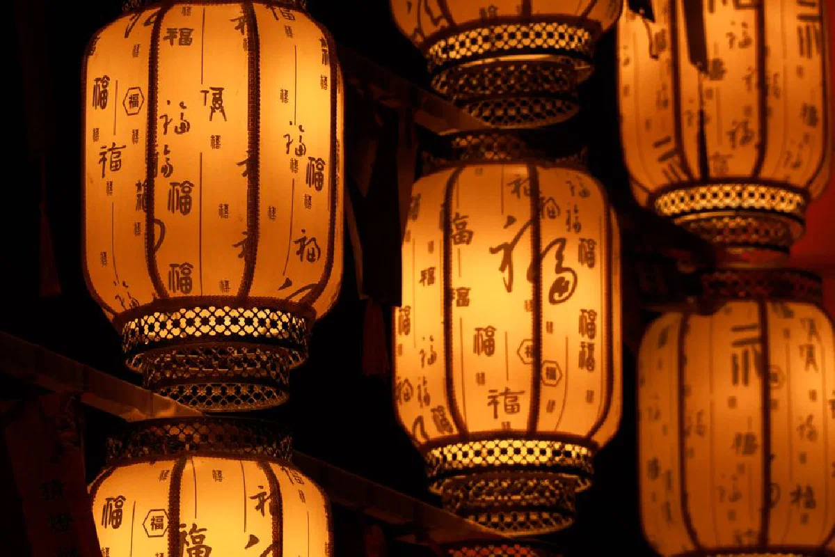 Warm glow of traditional Chinese lanterns decorated with calligraphy.
