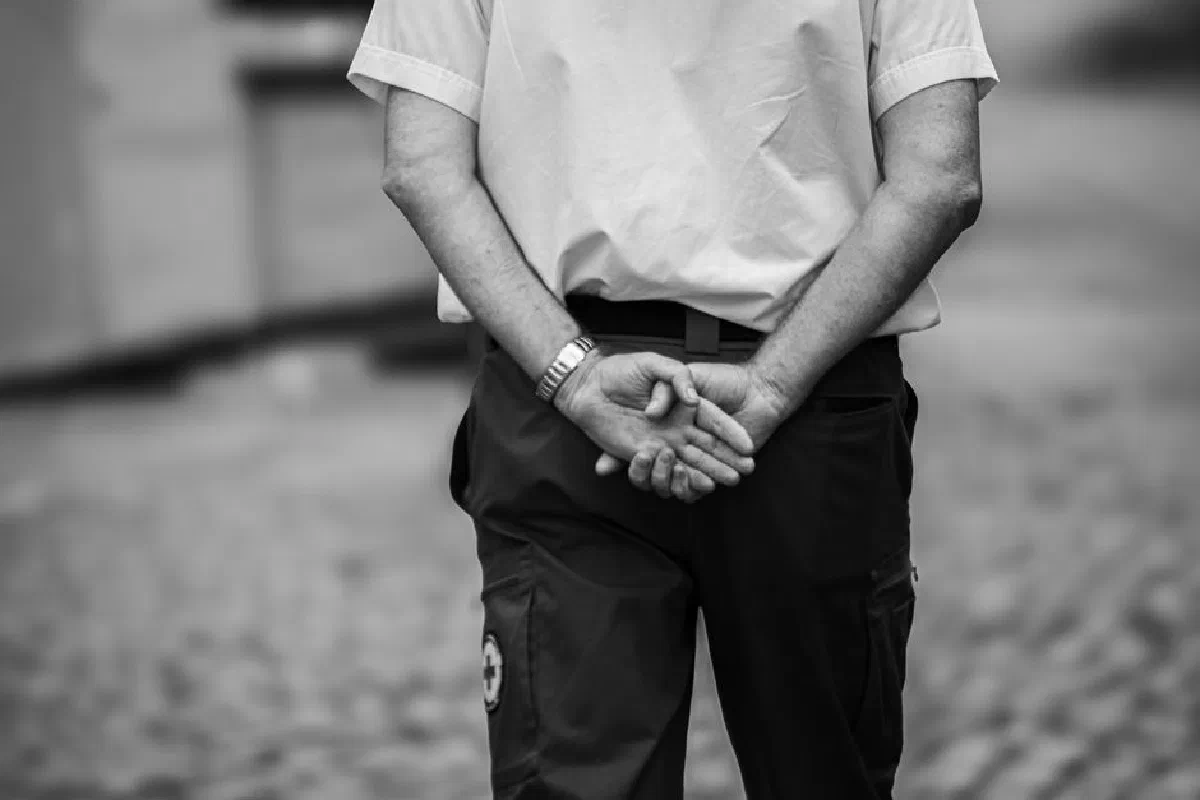 A monochrome photo capturing a professional in uniform standing outdoors with a calm posture in Dublin, Ireland.