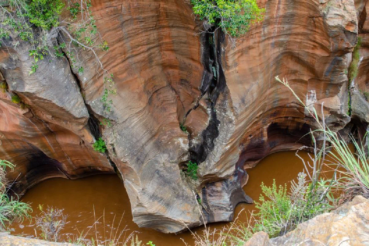 Stunning rock formations and water channels at Bourke's Luck Potholes, showcasing erosion.