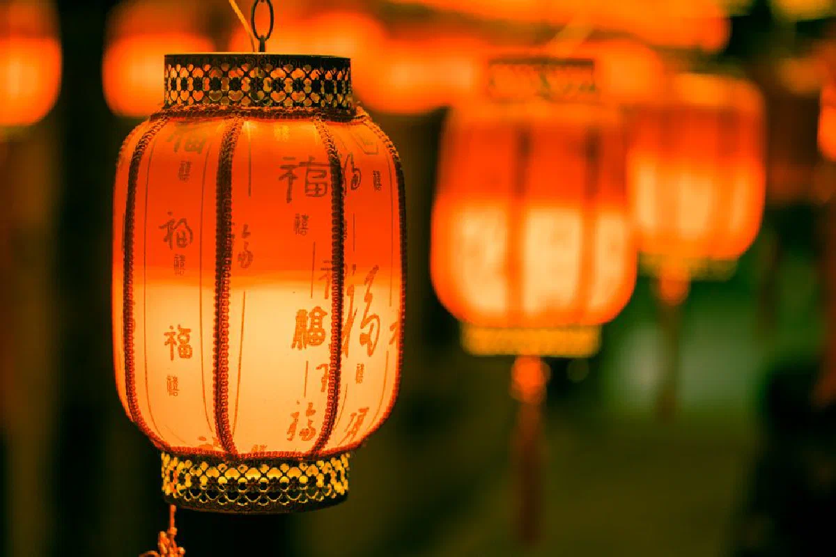 Vibrant red Chinese lanterns glowing warmly, creating a festive atmosphere.