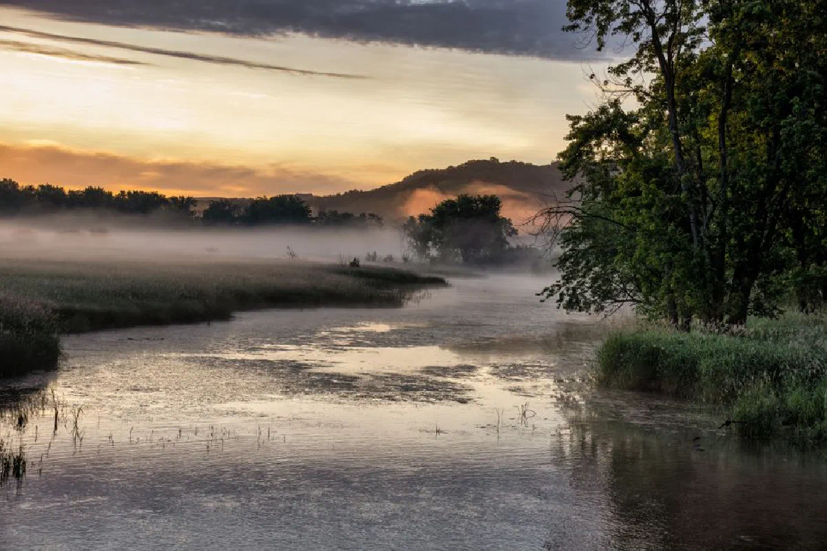 Tranquil morning scene with mist over a river in Modena, WI. Perfect for landscape and nature themes.