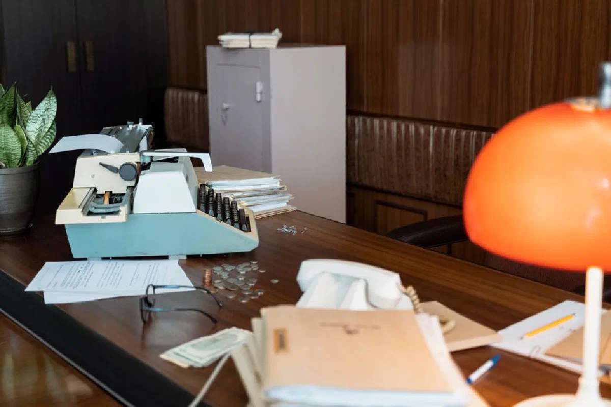 A nostalgic office scene with a vintage typewriter on a wooden desk.