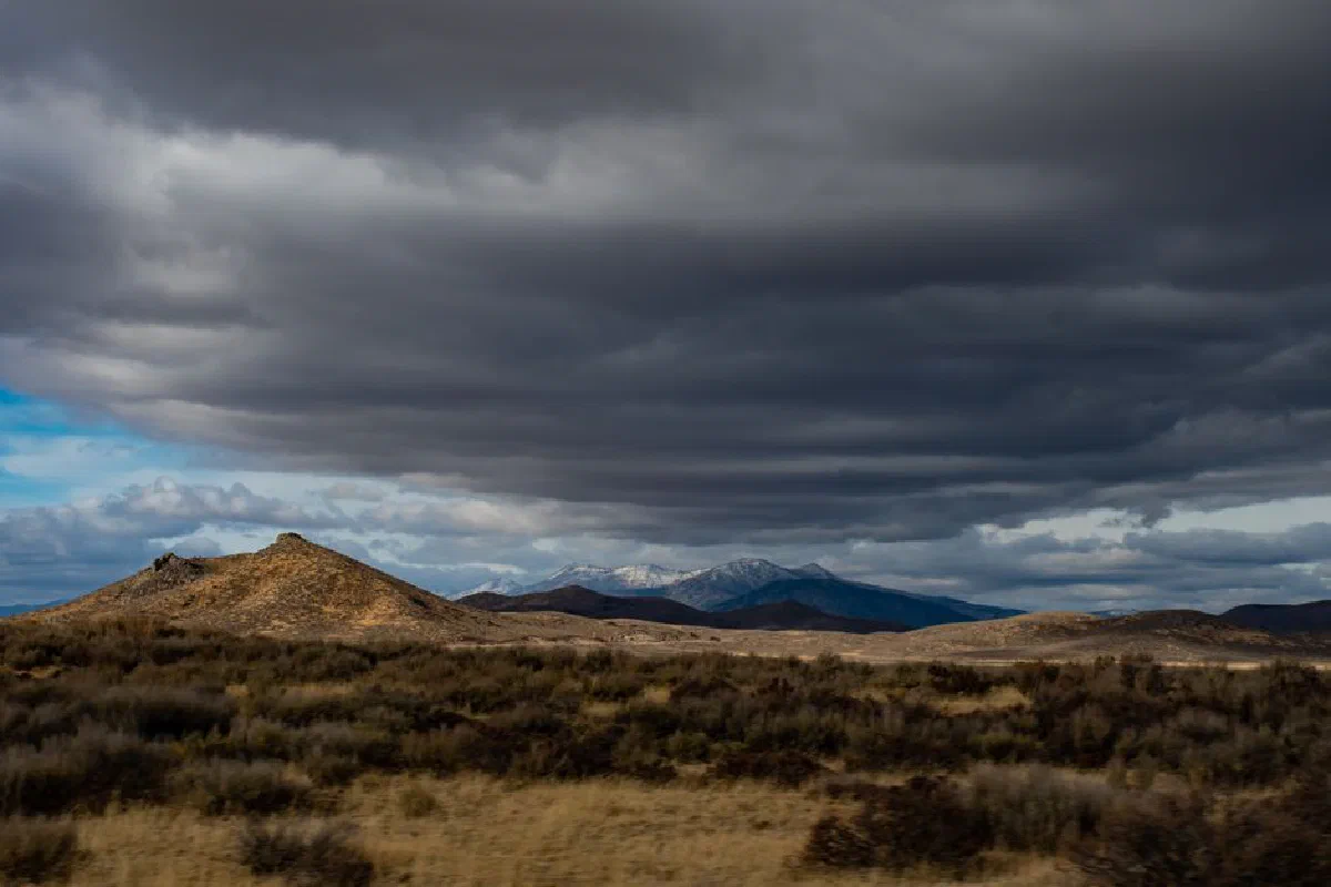 Capturing the dramatic cloudy skies over the serene landscape of Hill City, Idaho.
