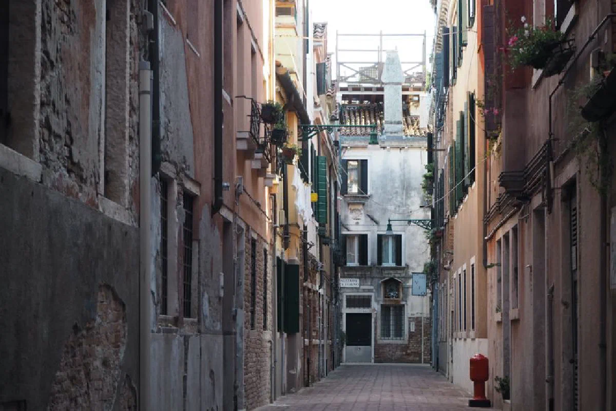 A picturesque narrow street in Venice, showcasing classic Venetian architecture and charm.