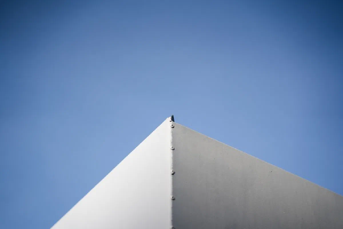 A minimalist architectural corner against a vivid blue sky showcasing simplicity and modern design.