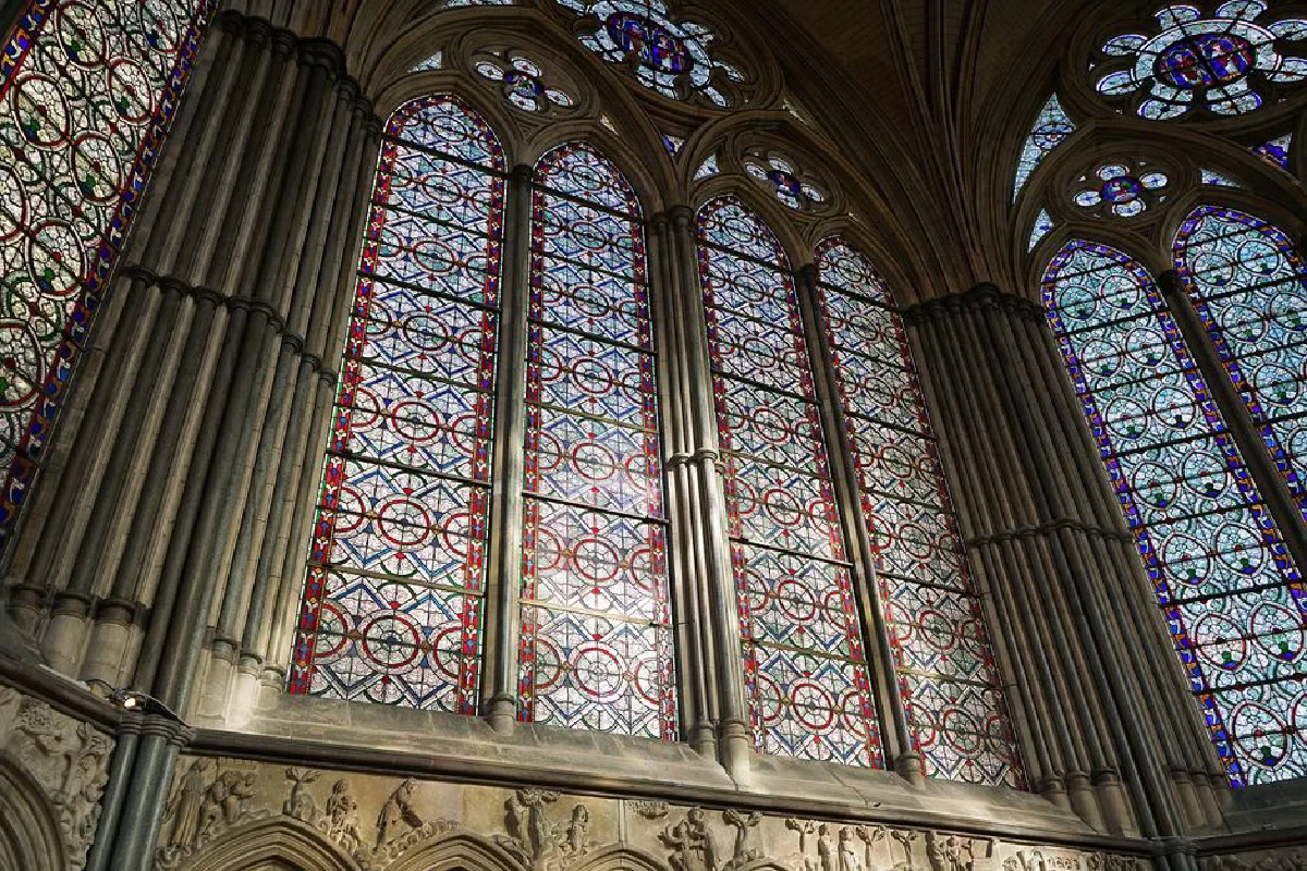 Intricate stained glass windows in Salisbury Cathedral, showcasing Gothic architecture.