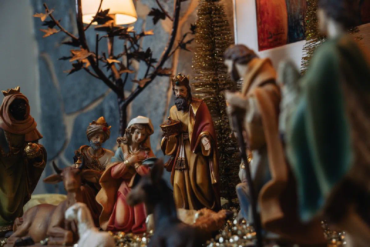 Intricate nativity scene figurines depicting the birth of Jesus in a warm setting.