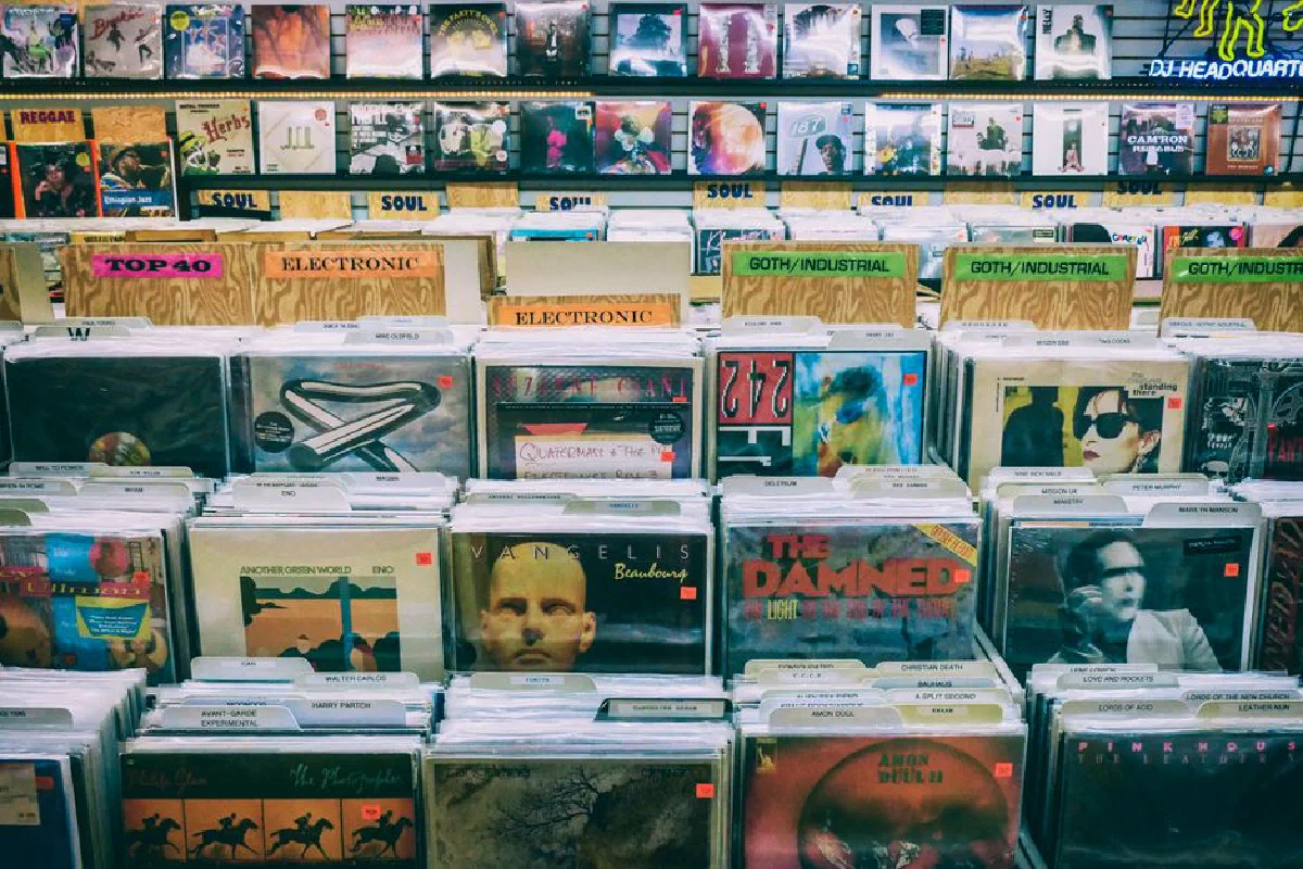 A vintage vinyl record display with diverse music genres in a classic music store.