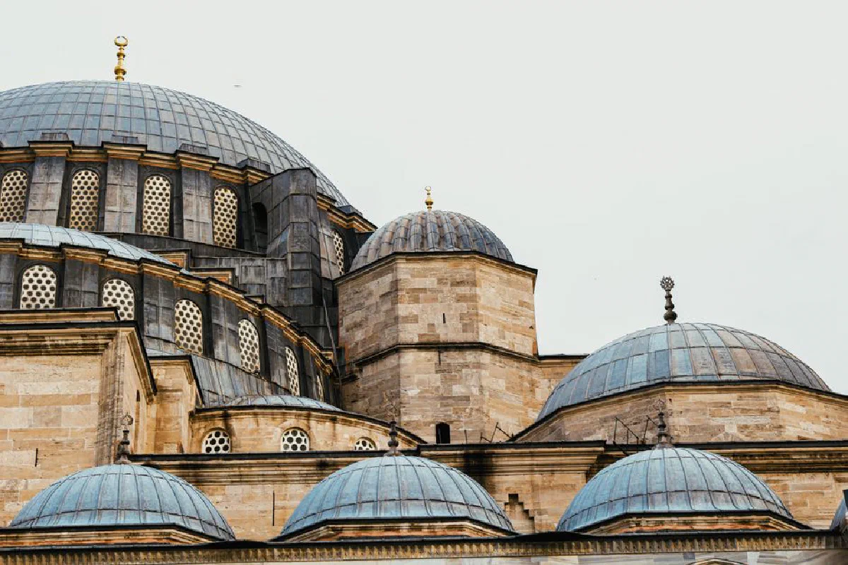 Detailed view of the domes and facade of Suleymaniye Mosque in Istanbul, showcasing Islamic architecture.