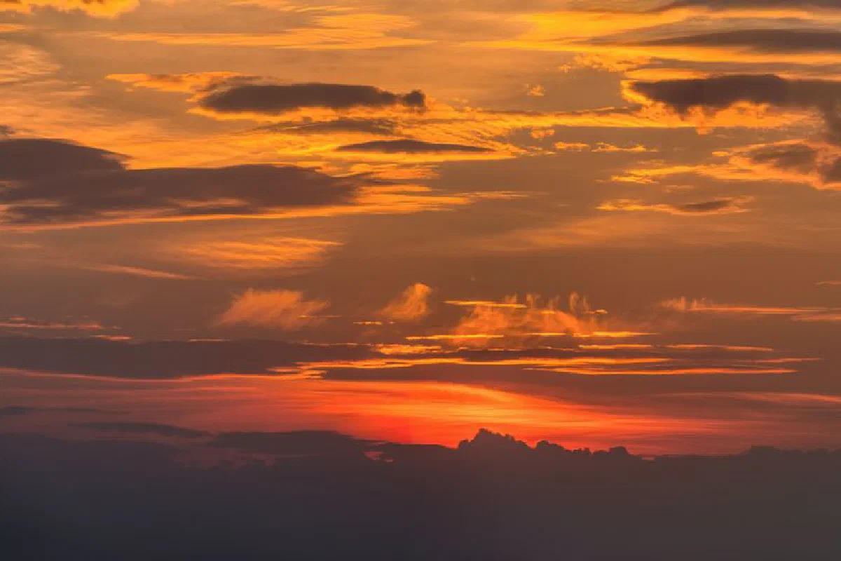 Stunning orange and red sunset sky with clouds over Minnesota, creating a captivating view.