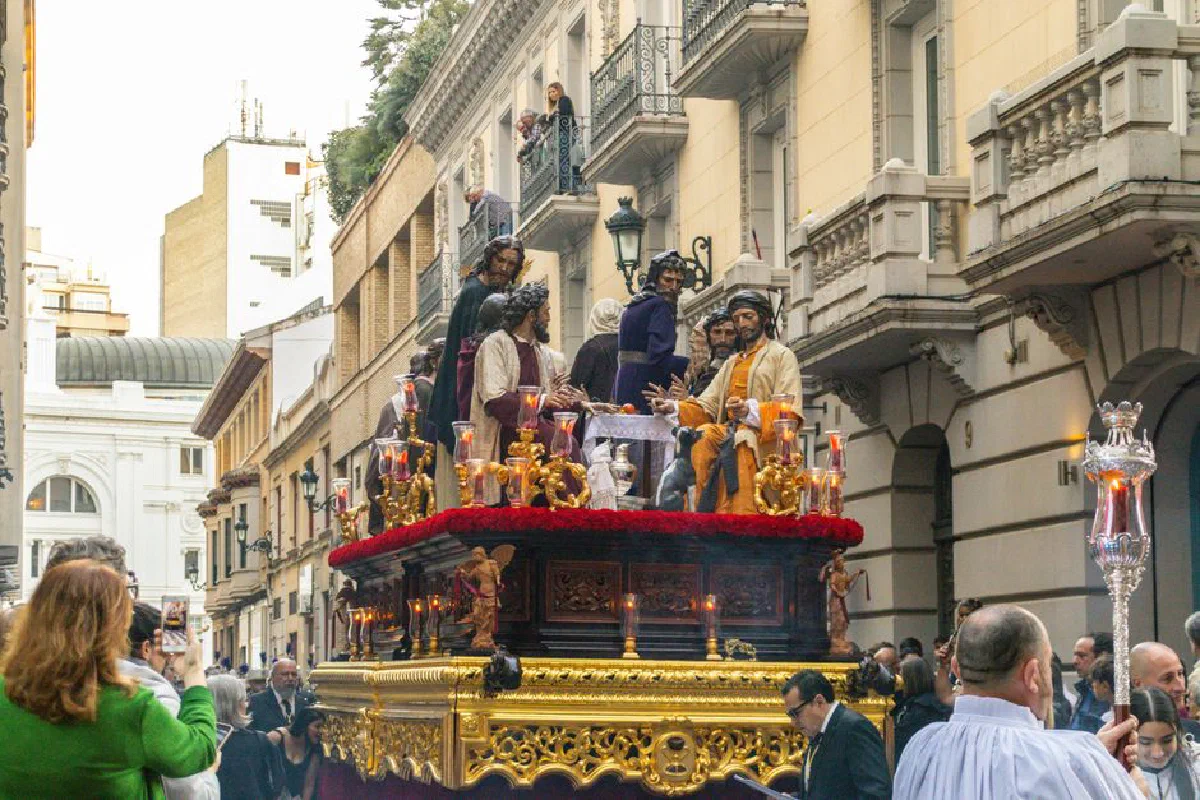 Vibrant religious procession in Zaragoza featuring traditional costumes and ornate floats.