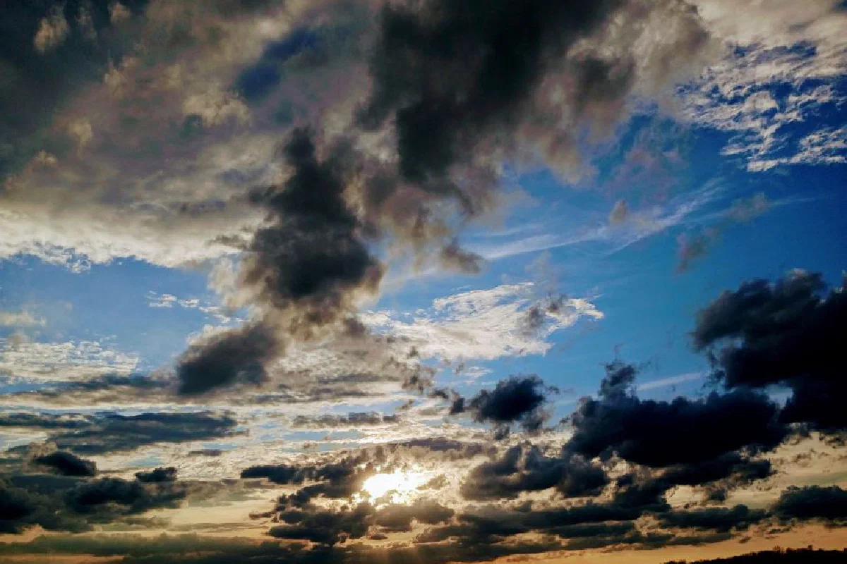 A captivating view of dark clouds with sunlight peeking through, creating a dramatic sky.