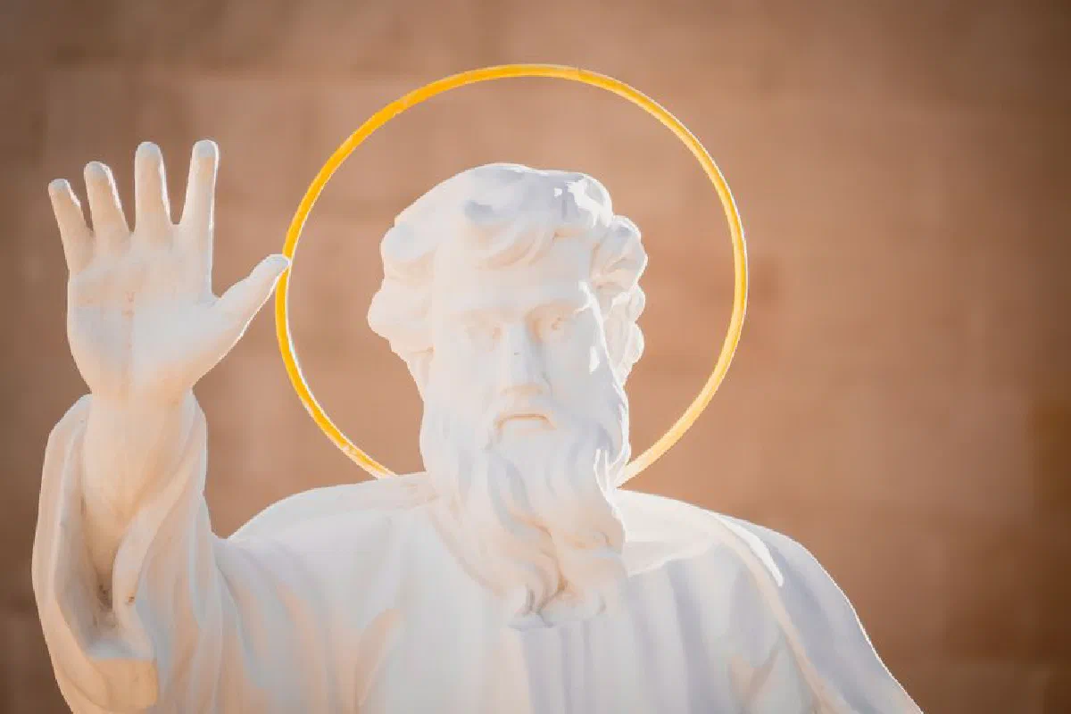 A serene white marble sculpture of a religious saint with a distinct halo, symbolizing peace and divinity.