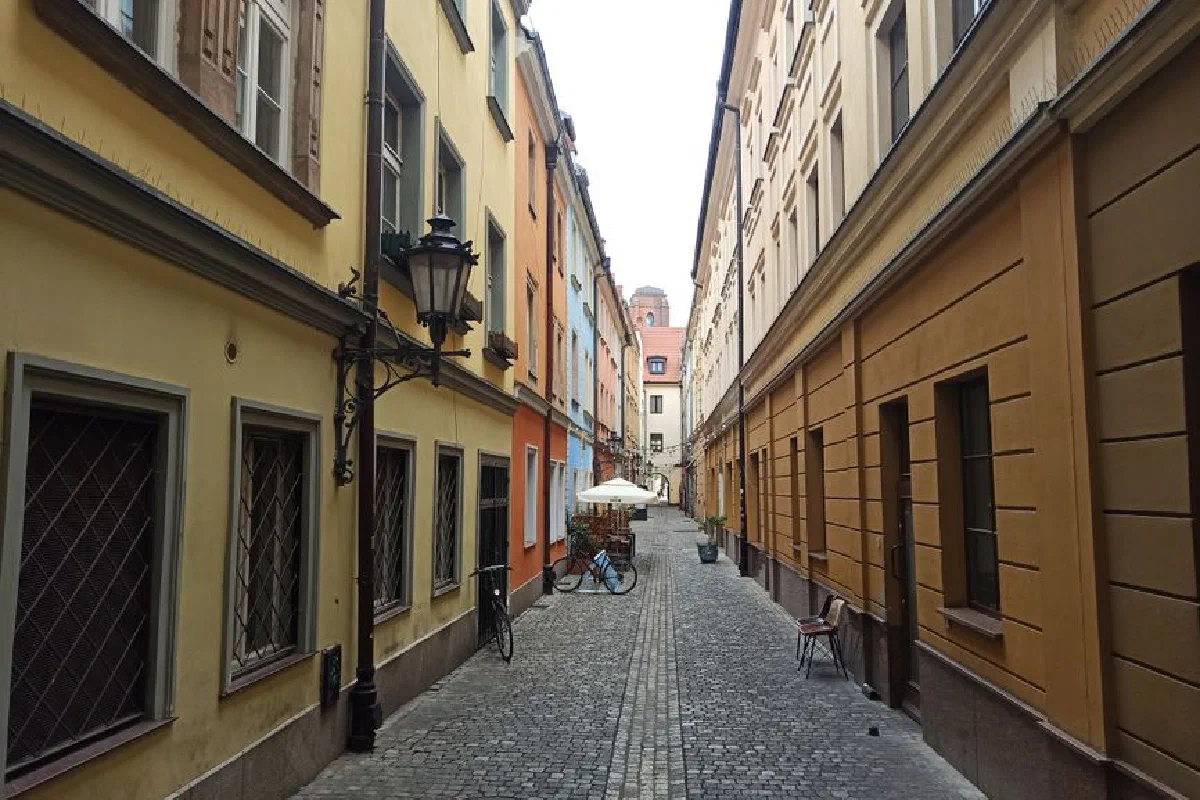 A picturesque cobblestone street in Wrocław, Poland's historic city center.