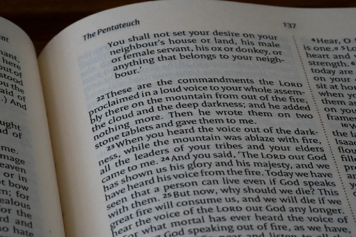 A close-up view of the Book of Deuteronomy text highlighting commandments.