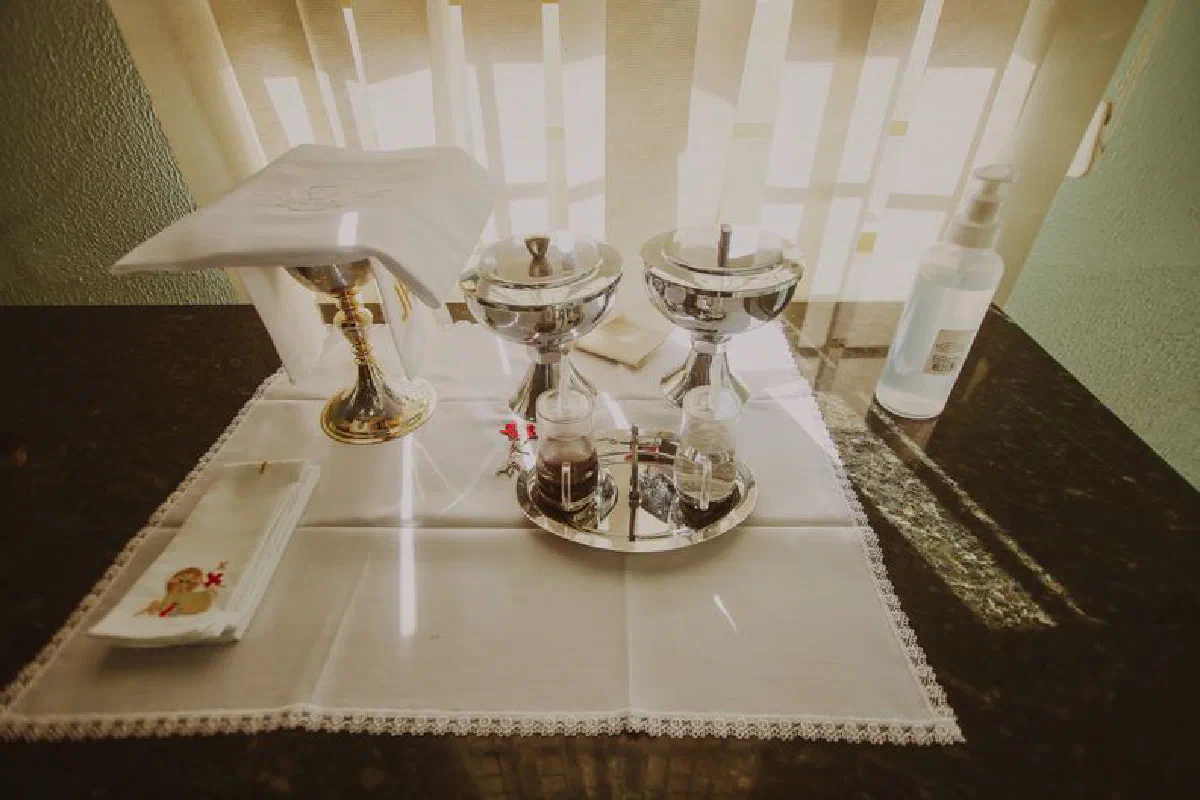 A serene display of silver chalices and religious artifacts on a church altar, symbolizing spirituality and worship.