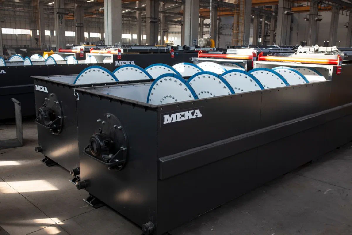 Large industrial machinery inside a modern manufacturing plant with natural lighting.