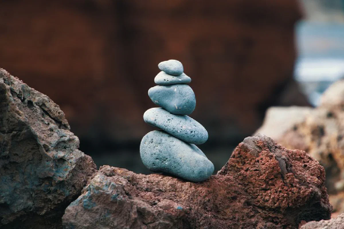 Peaceful arrangement of balanced stones in an outdoor rocky setting, symbolizing harmony.