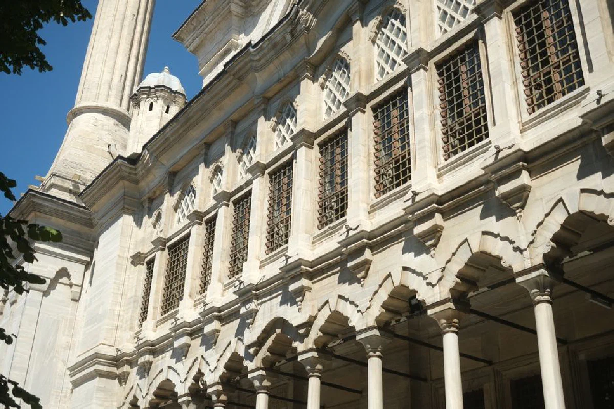 Elegant view of a historic Ottoman-style facade featuring intricate columns and lattice windows.