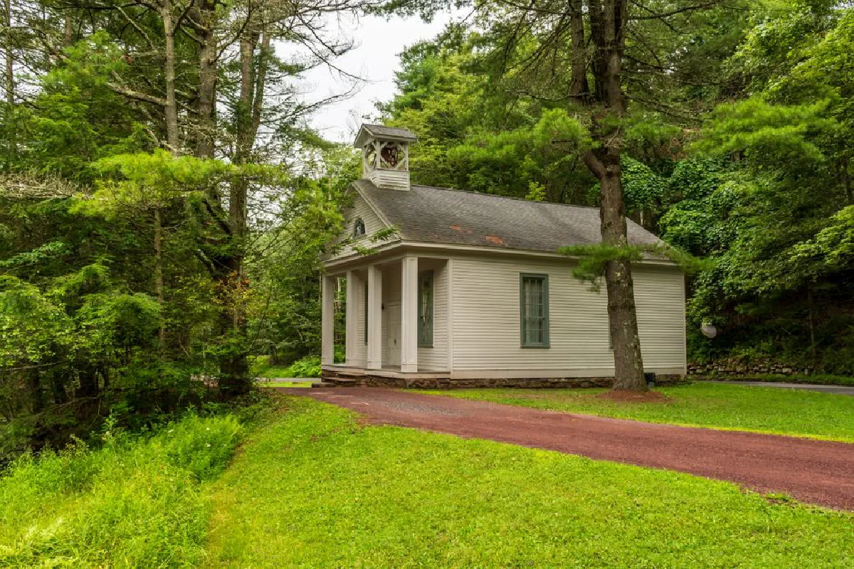 Charming wooden chapel set in a verdant forest, capturing the serene beauty of summer nature.