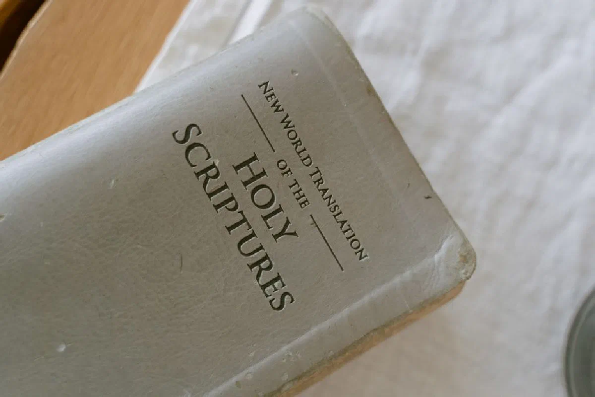 A close-up photo of the New World Translation of the Holy Scriptures on a table.
