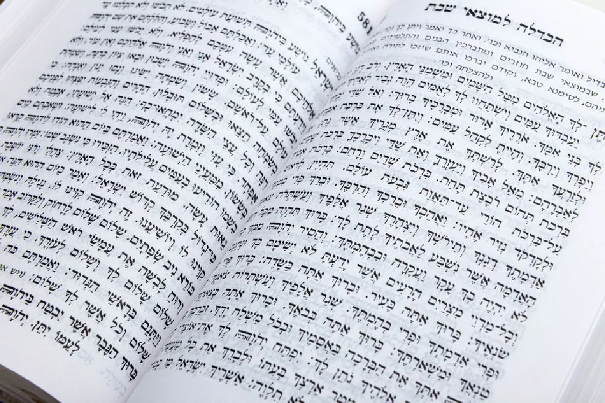 Close-up of an open book displaying Hebrew text, ideal for cultural or religious themes.