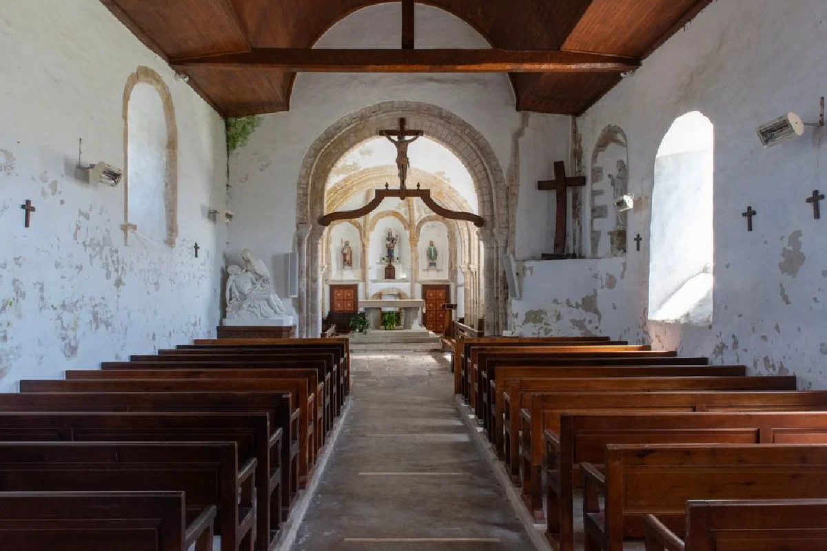 Explore the serene interior of a rustic church in La Hague, Normandië, capturing timeless architecture and peaceful ambiance.