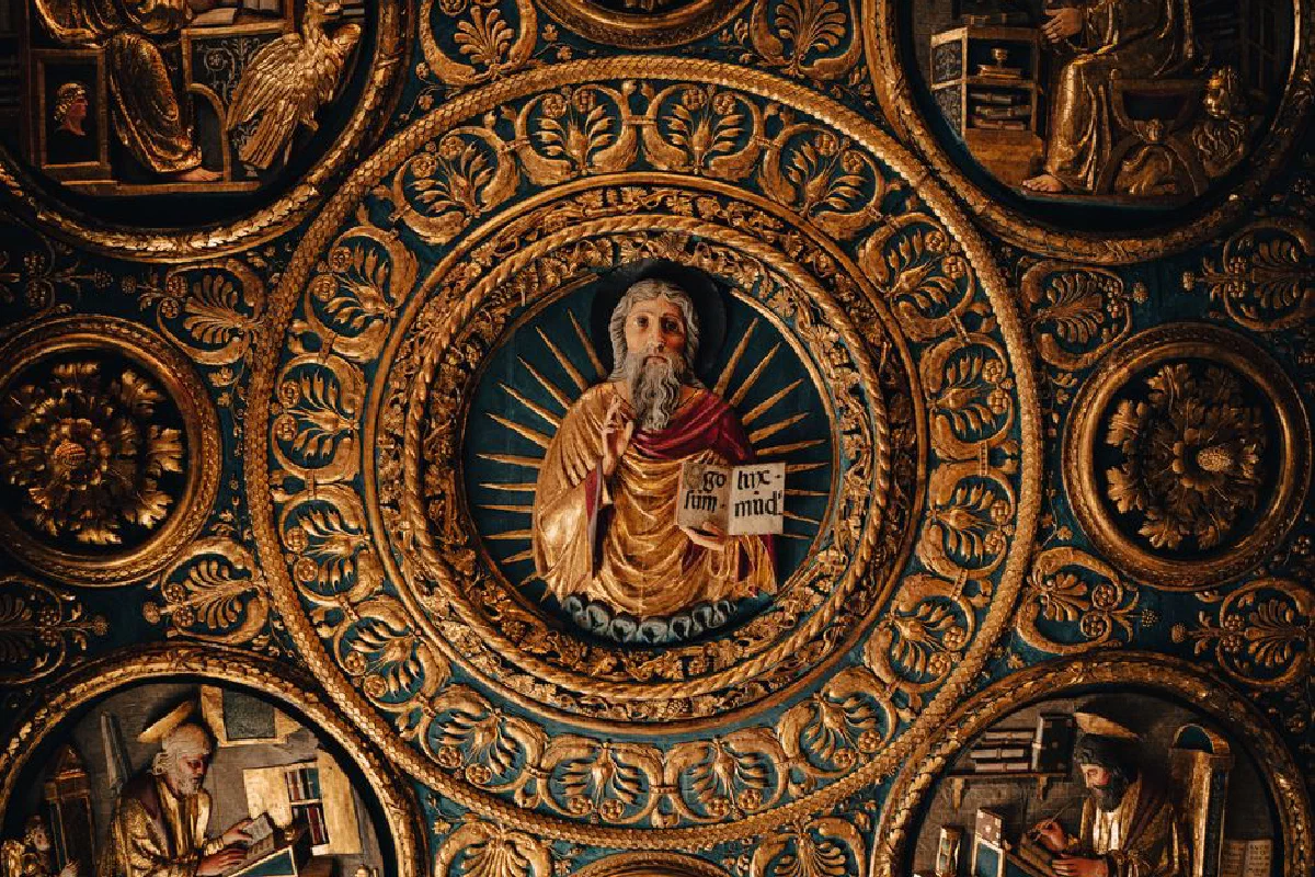 Intricate bas relief depicting a religious figure surrounded by ornate gold designs.
