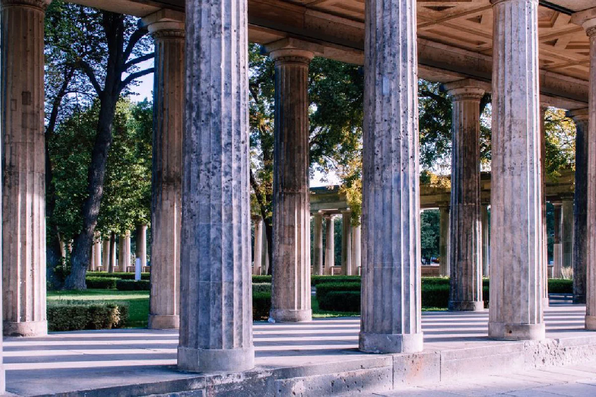 Classical columns in an outdoor setting, evoking ancient architecture.