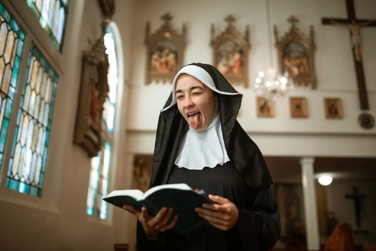 A humorous moment with a nun making a face while reading a book in a church.