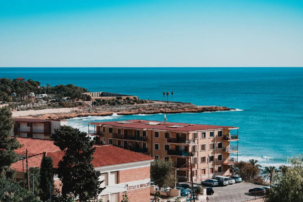 Aerial view of Tarragona's stunning coastline with clear blue skies and Mediterranean Sea.