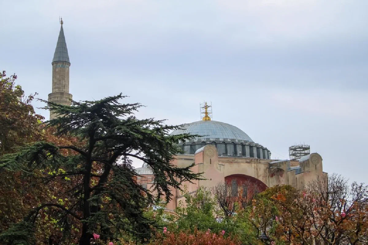 Captivating outdoor view of Hagia Sophia Grand Mosque surrounded by lush greenery in Istanbul, Turkey.