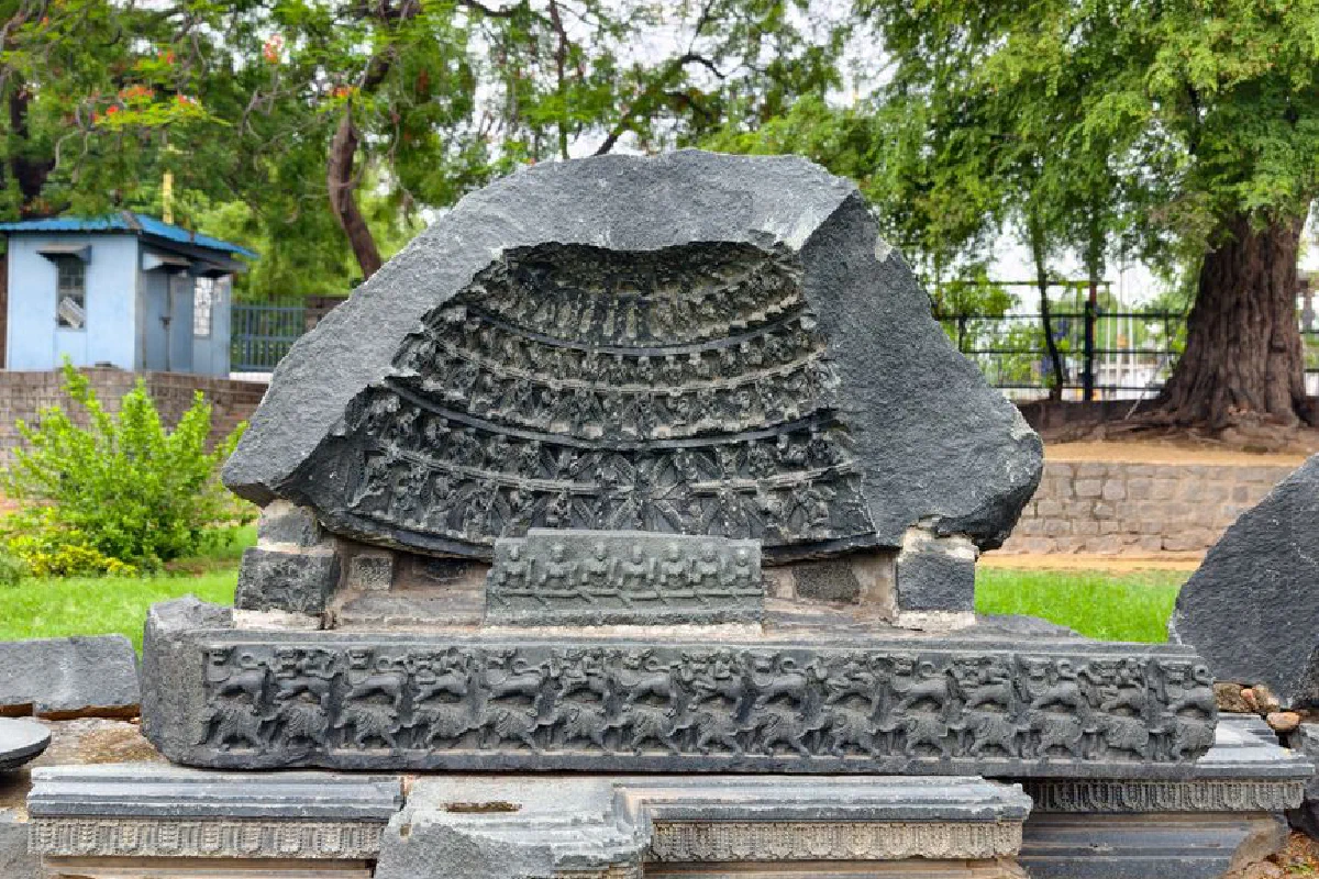 Intricate stone carving with historical design in an outdoor setting.
