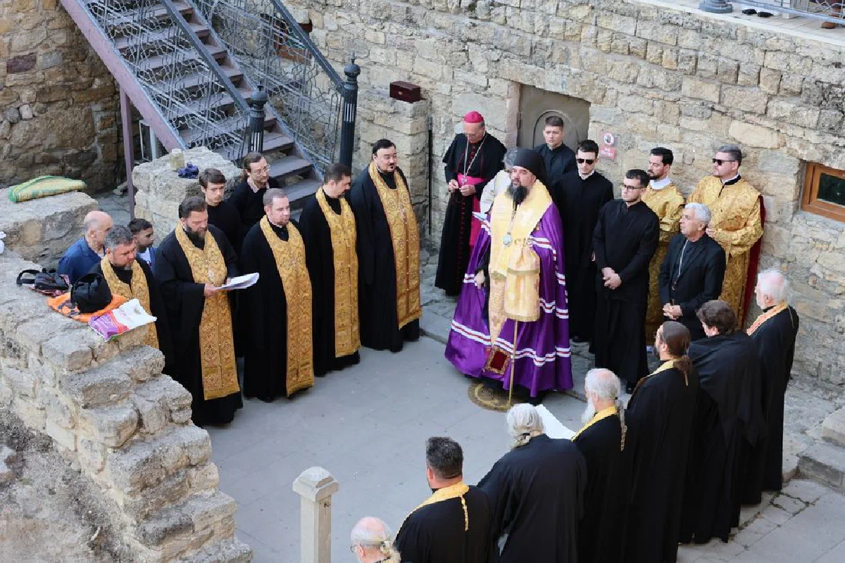 Orthodox clergy in ceremonial attire gathered for an outdoor religious service.