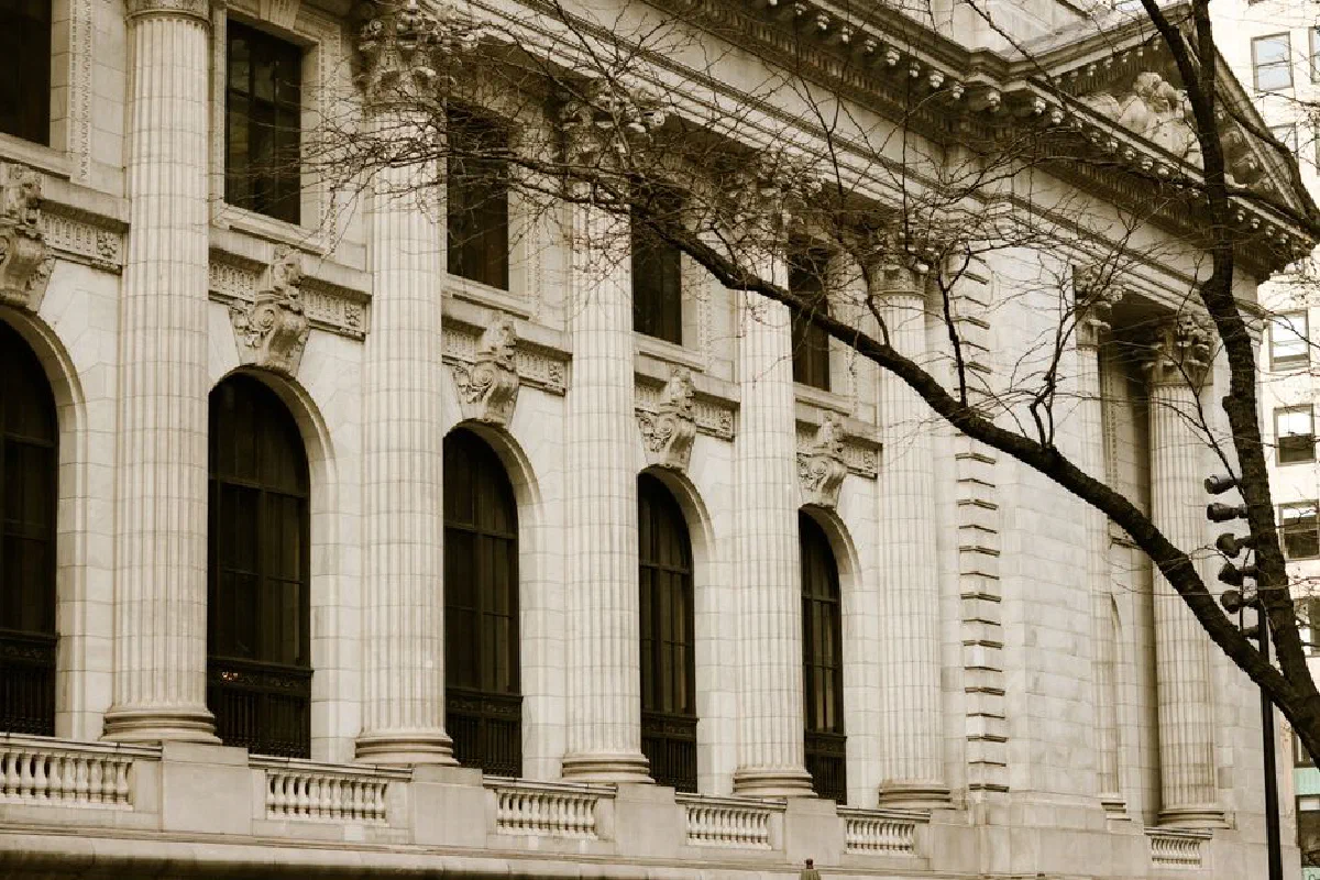 Detailed view of classic columns on a historic concrete building, highlighting exterior design.