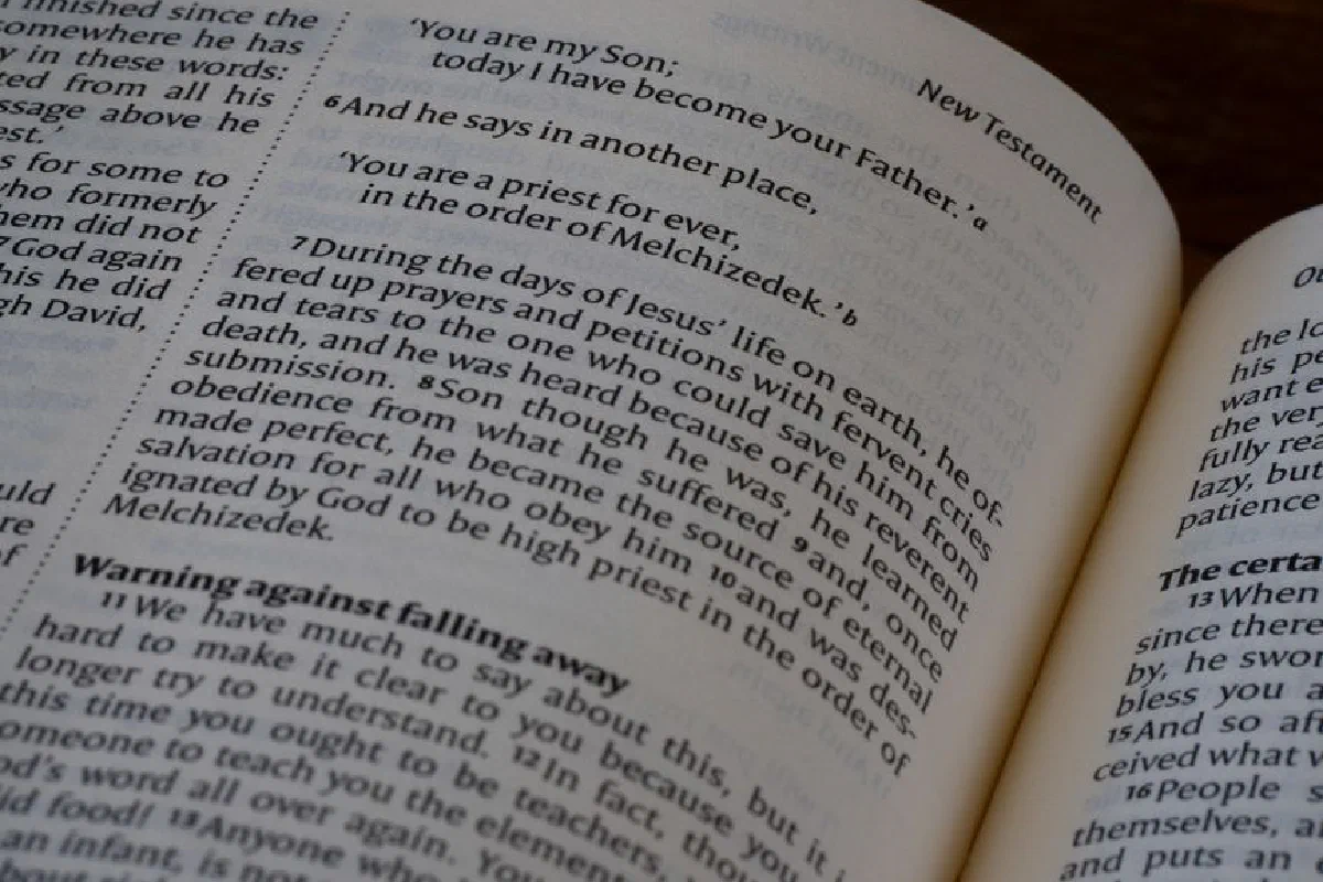 Detailed close-up of a Bible page from the New Testament highlighting scripture and themes of Christianity.