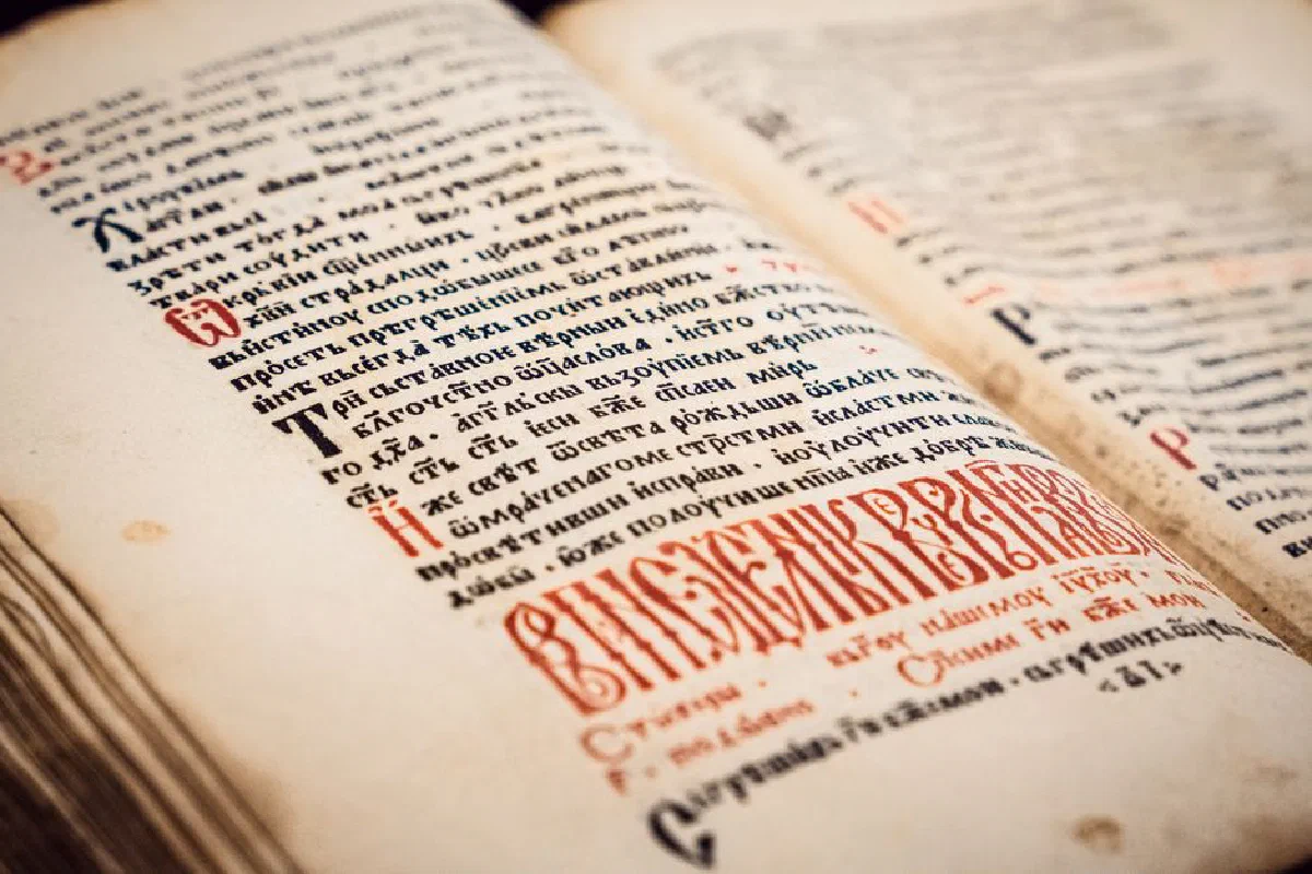 Close-up view of an ancient Serbian manuscript with elaborate script and colorful text.