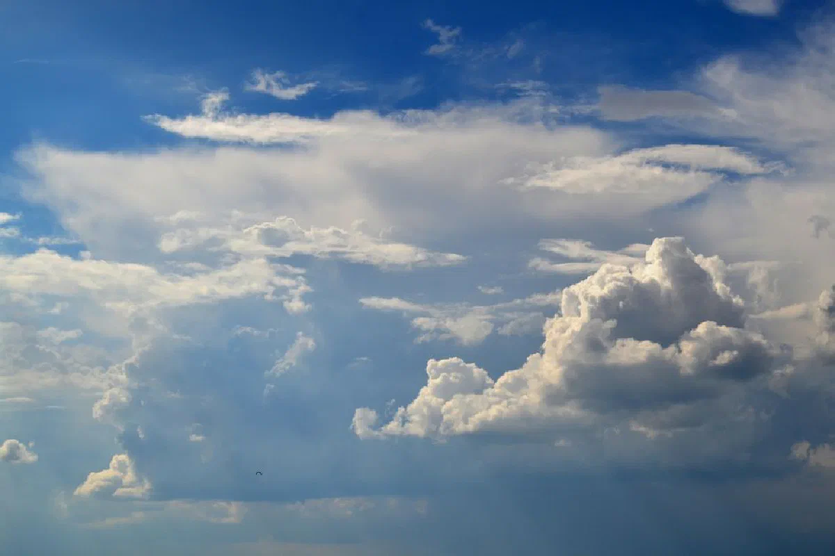 Beautiful cumulus clouds under a vibrant blue sky, capturing the essence of a perfect summer day.