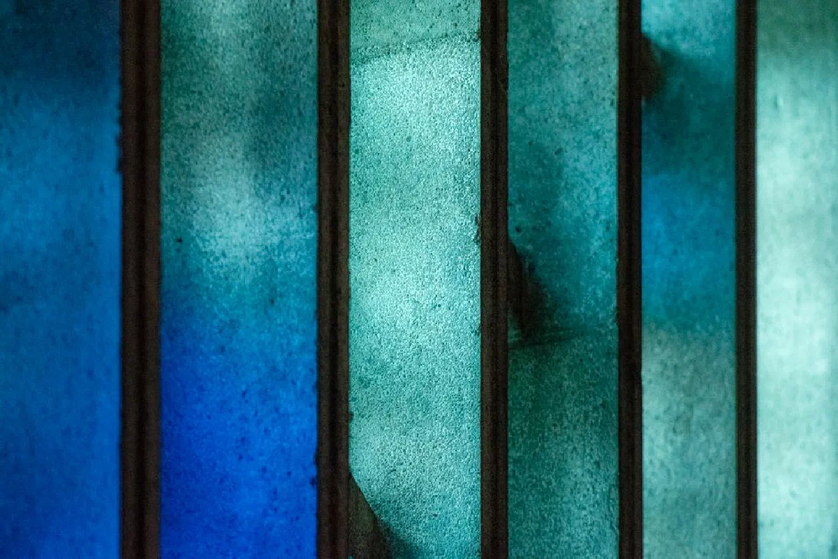 Close-up of blue stained glass panels with varying shades of blue and texture.