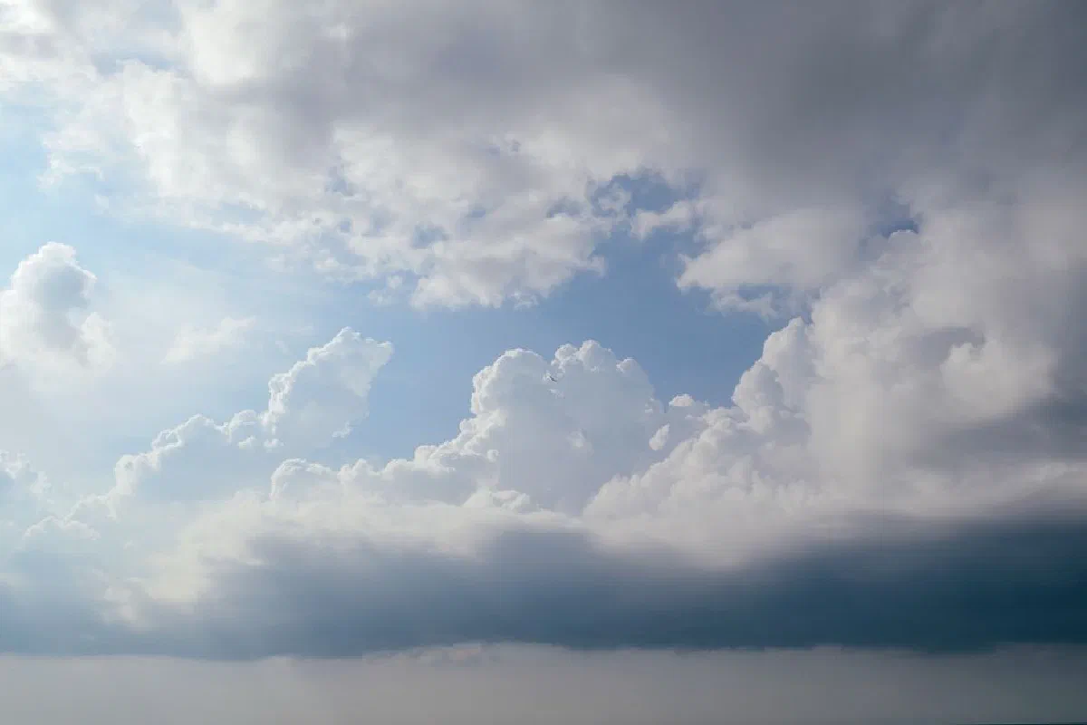 Serene view of dramatic cloud formations against a bright sunlit sky.