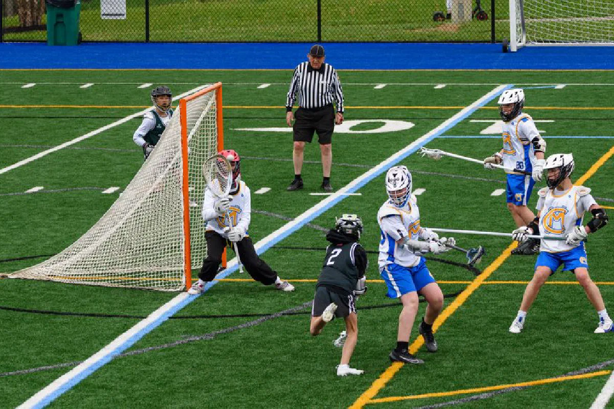 Intense youth lacrosse match with players in action at a sports field. Captivates competitive spirit and teamwork.
