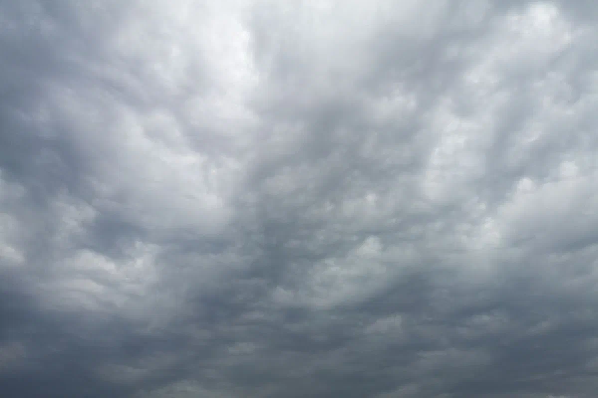 A moody overcast sky filled with thick, dramatic clouds suggesting changing weather.