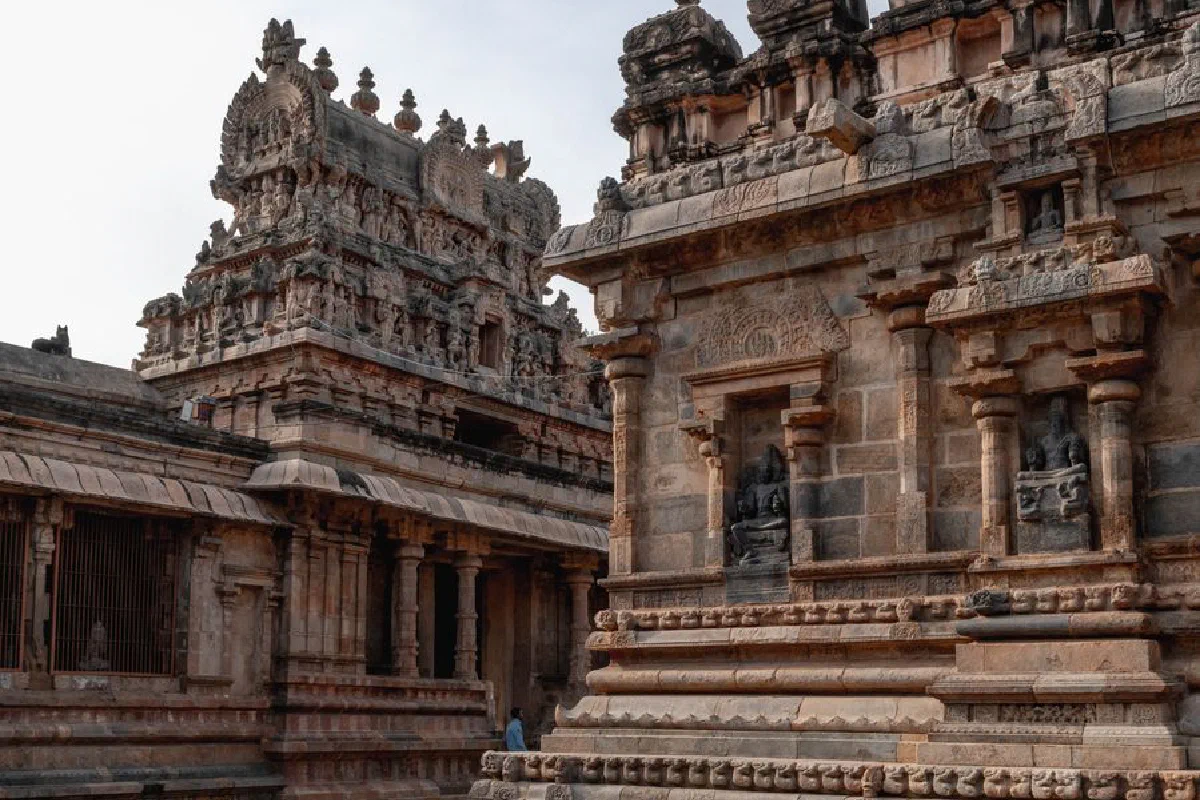 Detailed view of ancient stone carvings at a temple in Kumbakonam, Tamil Nadu, showcasing intricate Dravidian architecture.