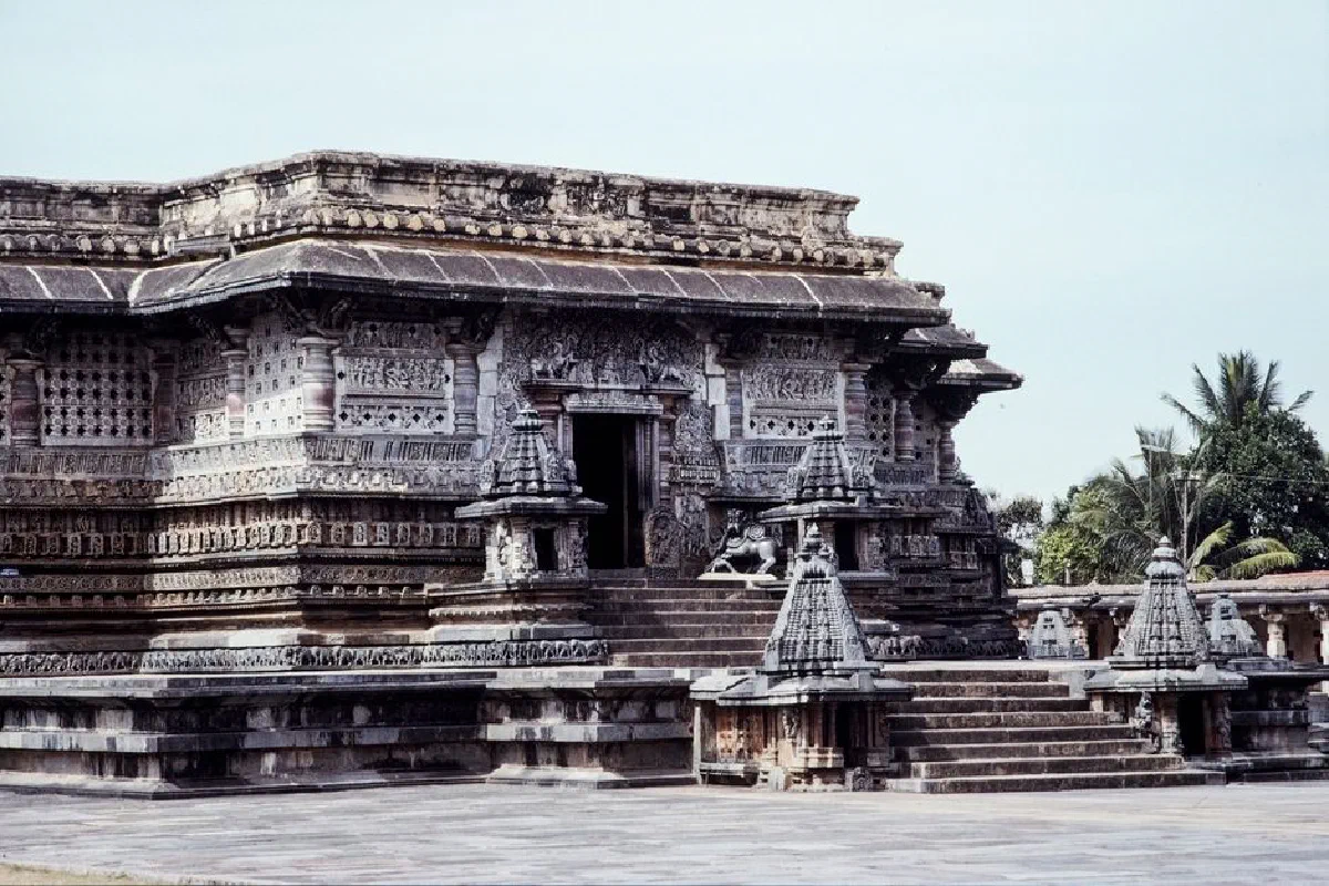A view of an intricately carved ancient stone temple in India, showcasing historic architecture.