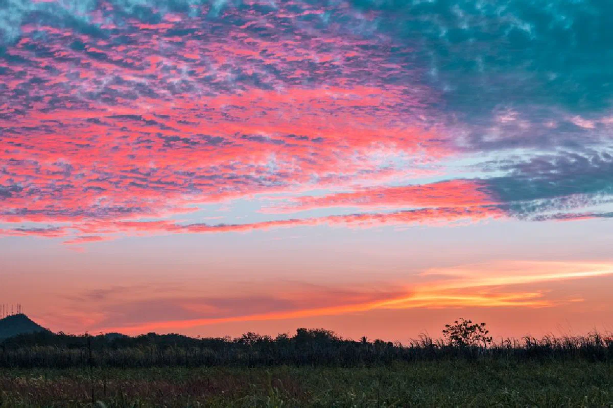 Stunning pastel sky at sunset over a serene natural landscape, evoking tranquility and wonder.