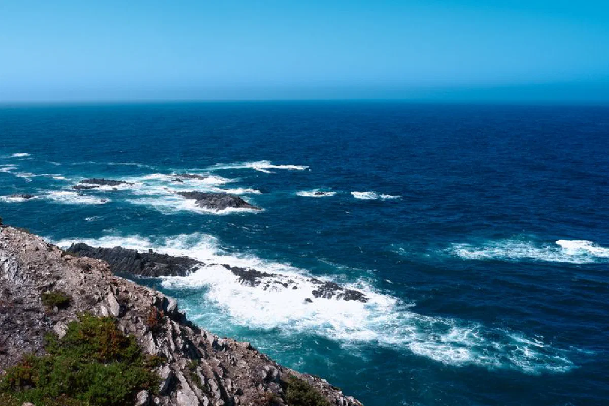 Stunning view of rugged cliffs and ocean waves on the Beja District coast, Portugal.