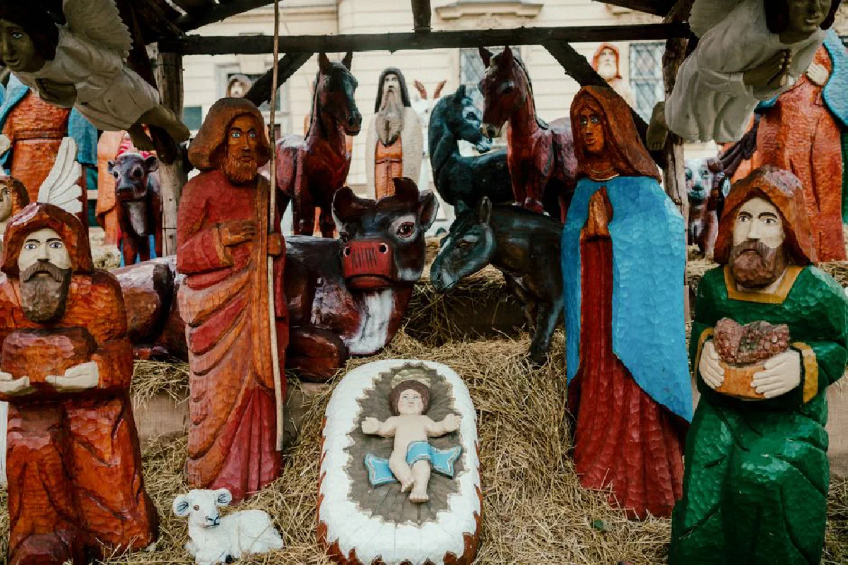 Colorful wooden nativity scene depicting biblical characters and animals.