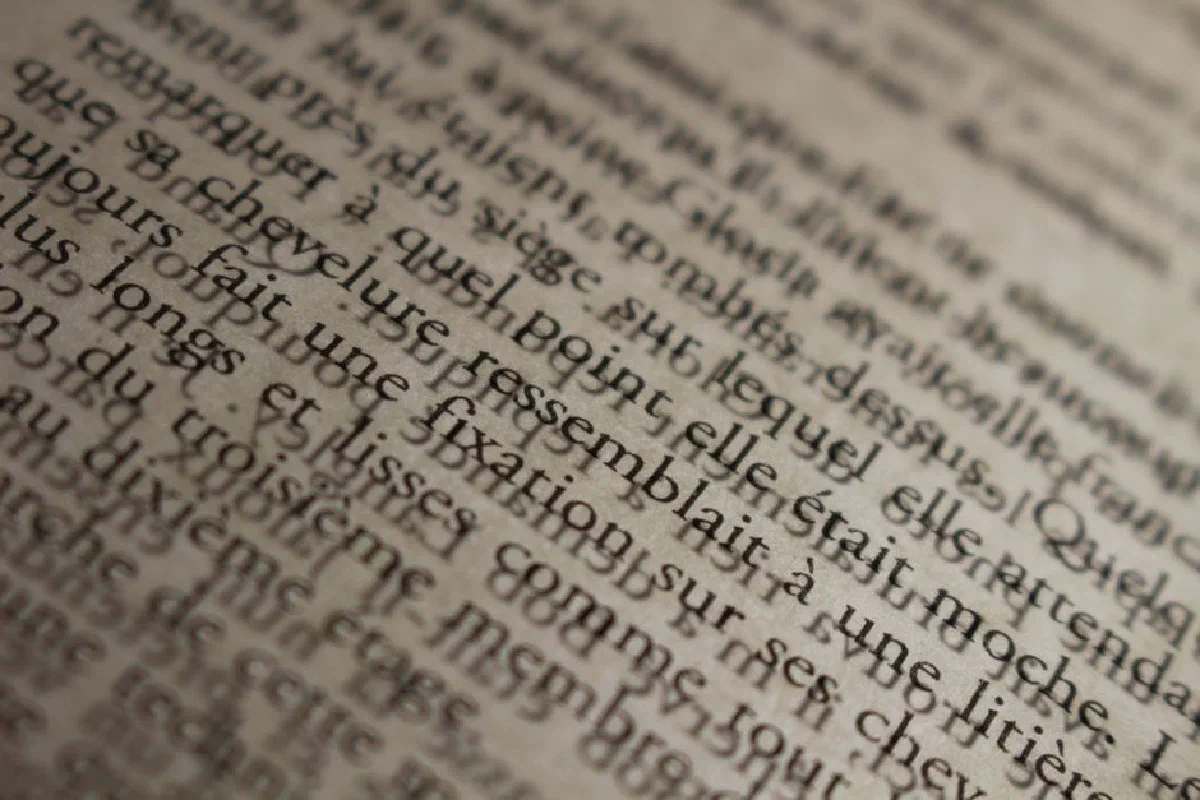 Detailed macro shot of old French text, showcasing vintage typography and texture.