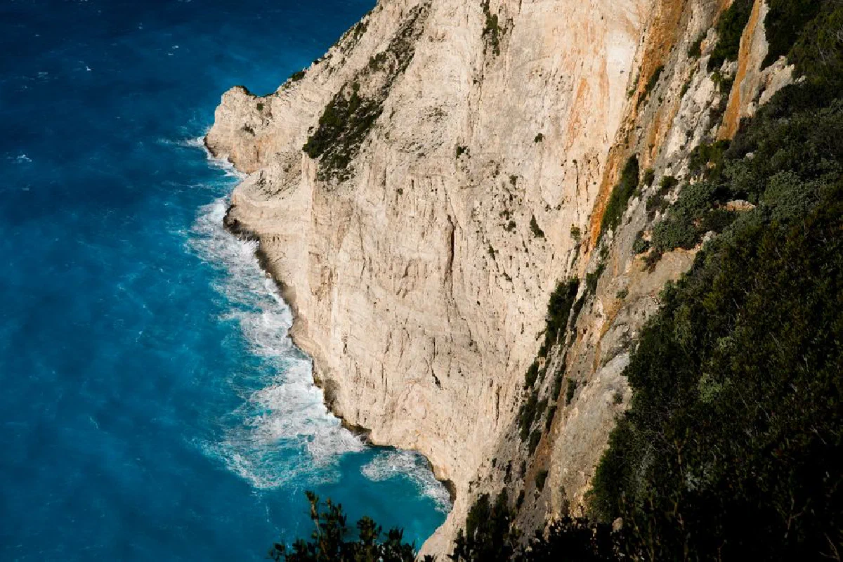Stunning view of the towering coastal cliffs and vibrant blue sea in Zakynthos, Greece.