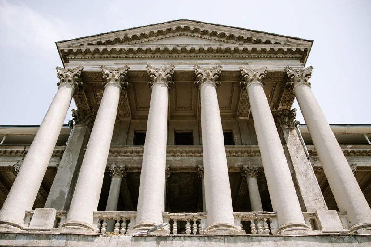 Low-angle view of classic architecture with ornate columns and detailed facade, showcasing historic grandeur.